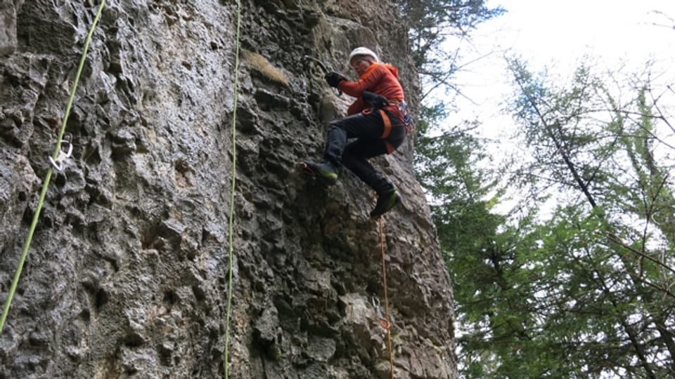 Robert Jasper klettert mit Pickel und Steigeisen am Kalksteinfels zwischen Diegten und Eptingen